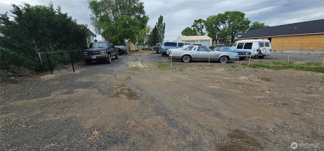 a view of street with parked cars