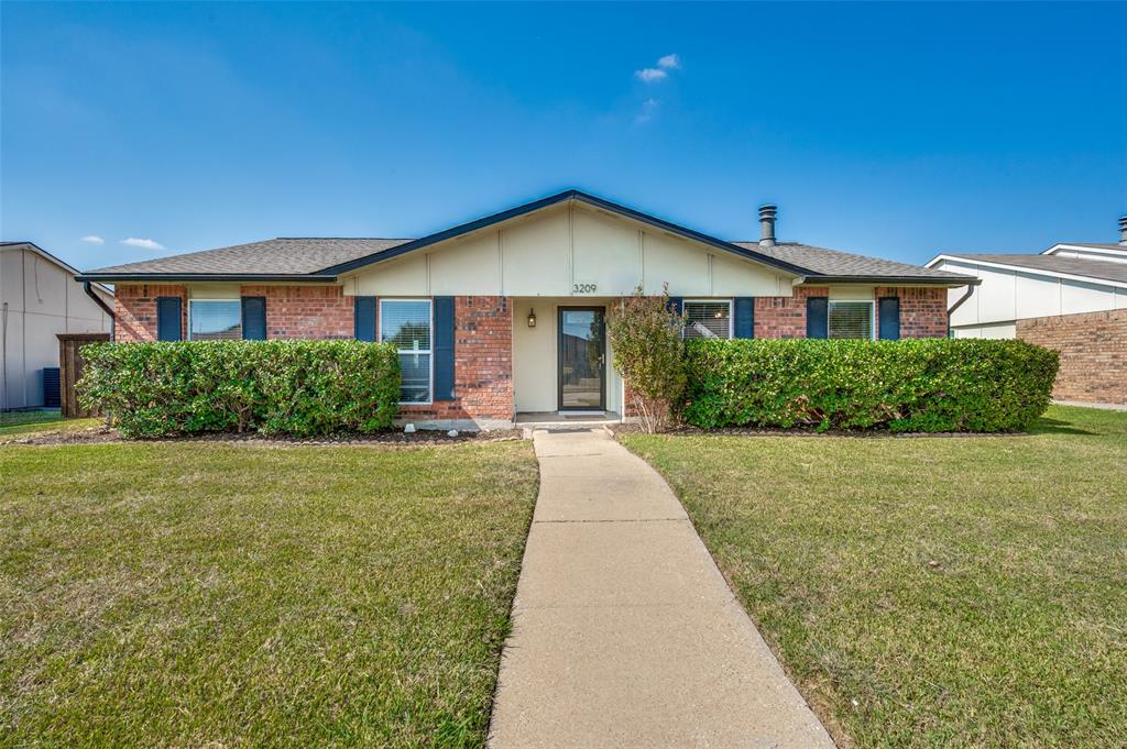 3209 Rose Hill Road Carrollton, TX 75007 - Photo 1 of 1 a front view of a house with yard and green space