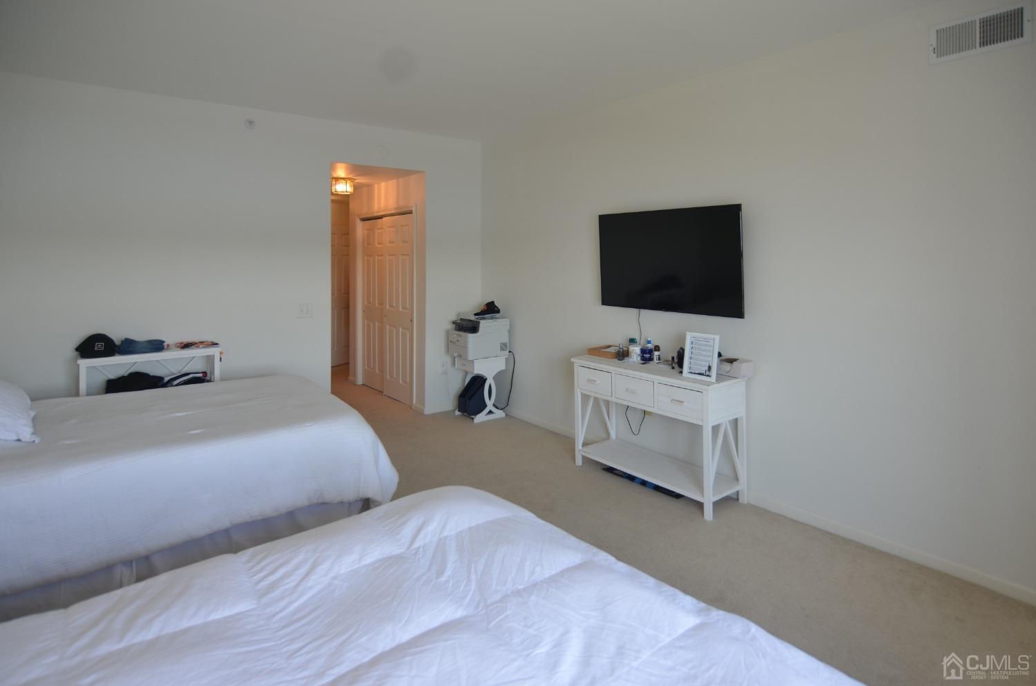 358 Rector Street, Unit 710 Perth Amboy, NJ 08861 - Photo 17 of 35 a bedroom with a bed and a flat screen tv