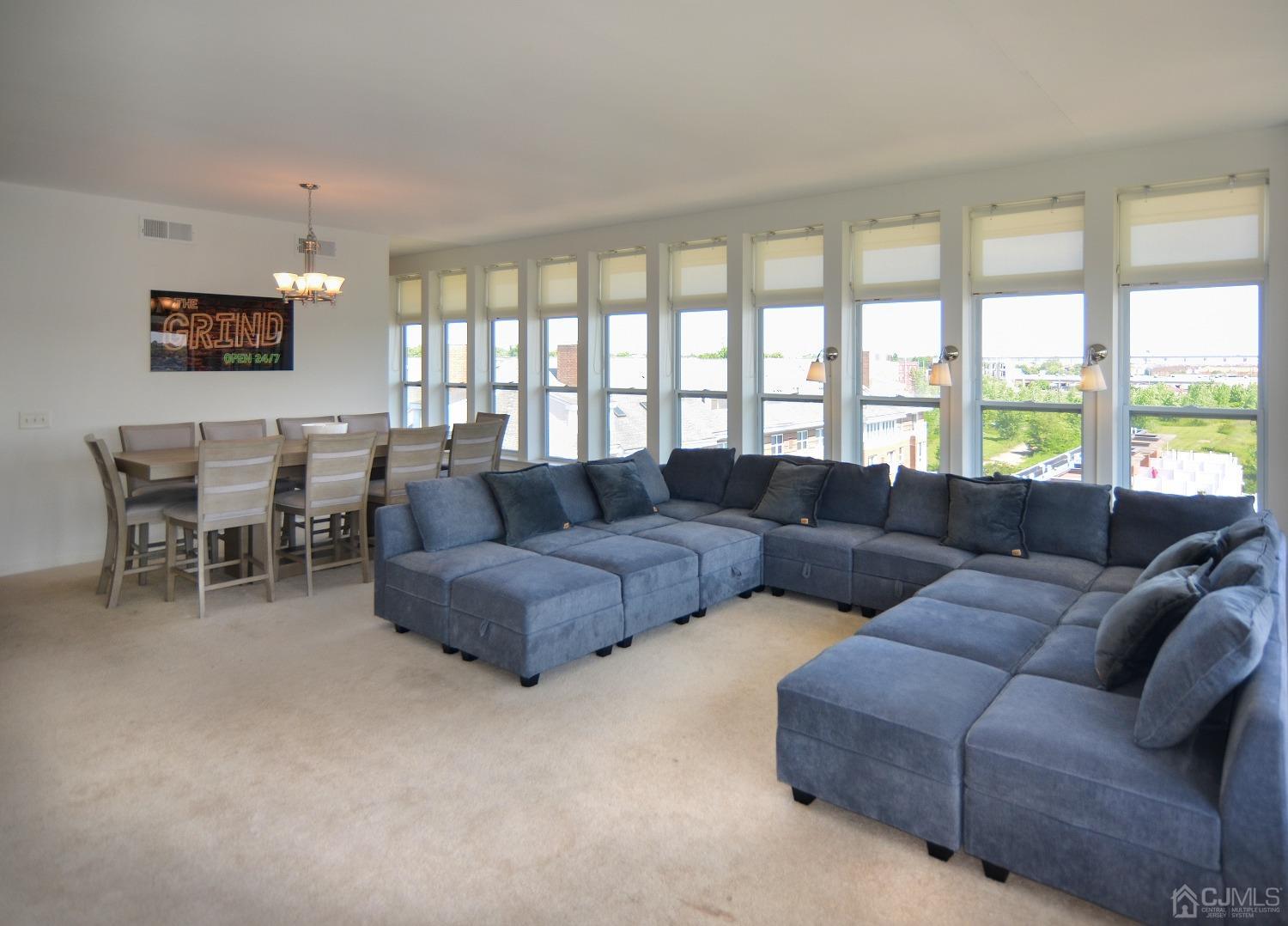 358 Rector Street, Unit 710 Perth Amboy, NJ 08861 - Photo 5 of 35 a living room with furniture and a large window