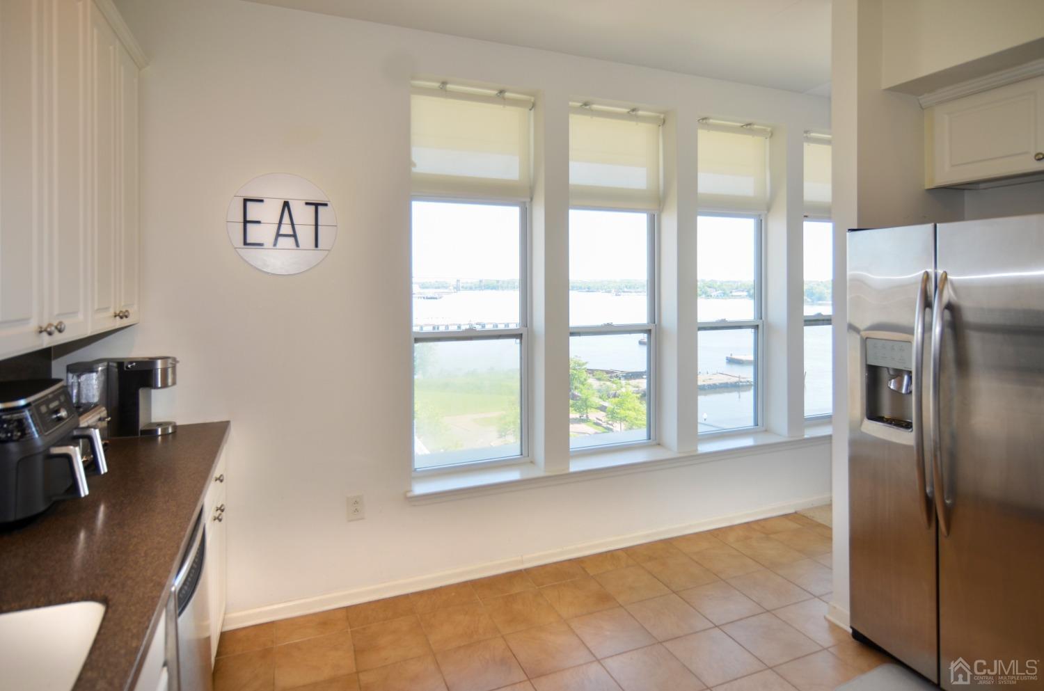 358 Rector Street, Unit 710 Perth Amboy, NJ 08861 - Photo 9 of 35 a view of a kitchen with furniture and a refrigerator