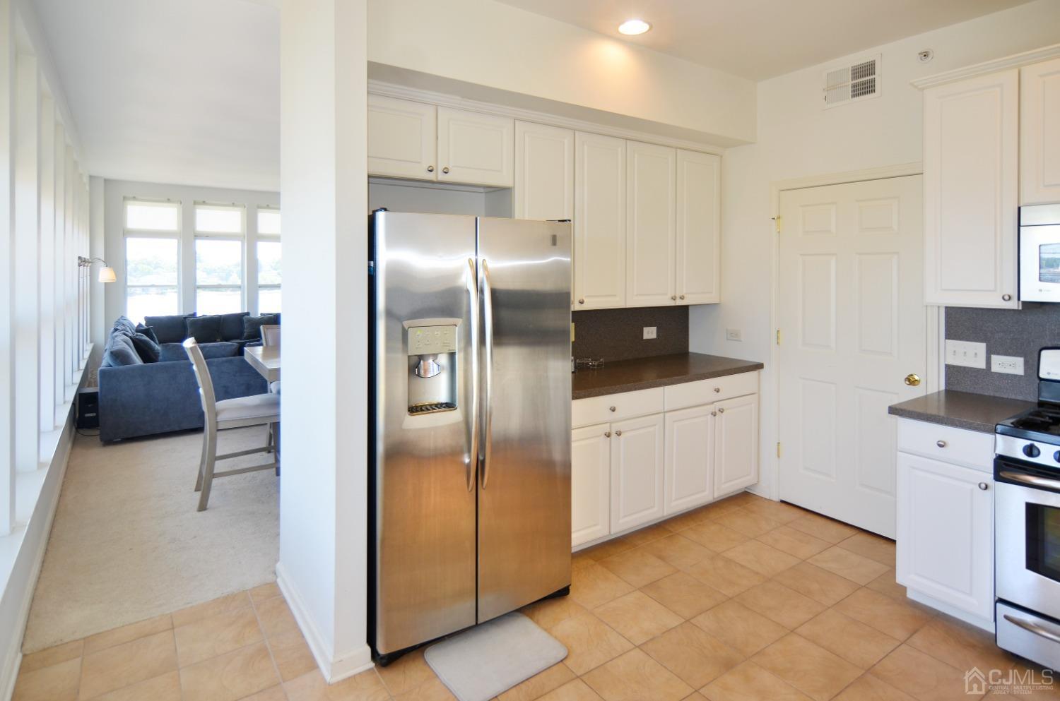 358 Rector Street, Unit 710 Perth Amboy, NJ 08861 - Photo 10 of 35 a kitchen with a refrigerator sink and cabinets