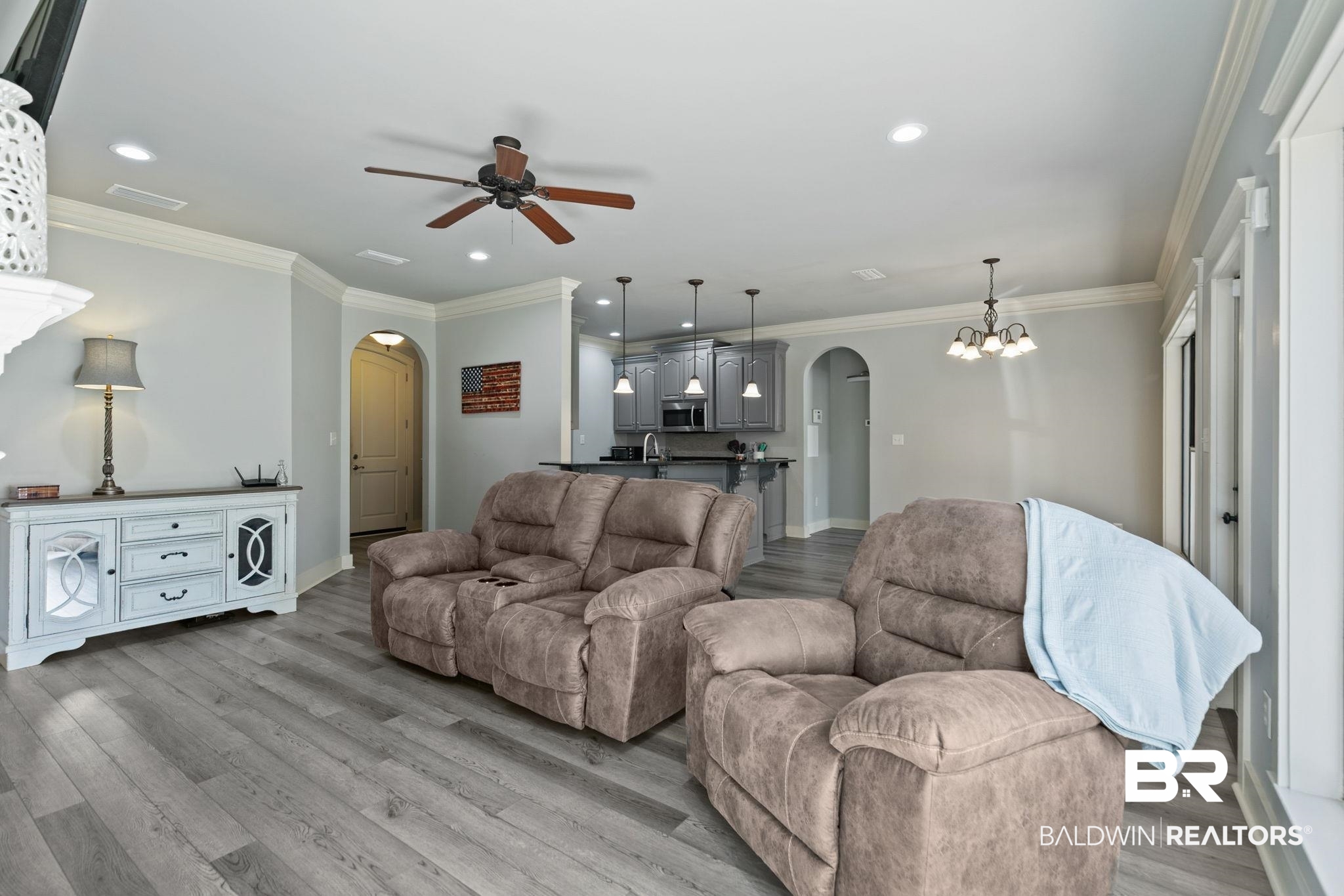 9584 Sanibel Loop Daphne, AL 36526 - Photo 11 of 48 Living area with arched walkways, ornamental molding, ceiling fan, light wood-style floors, and recessed lighting