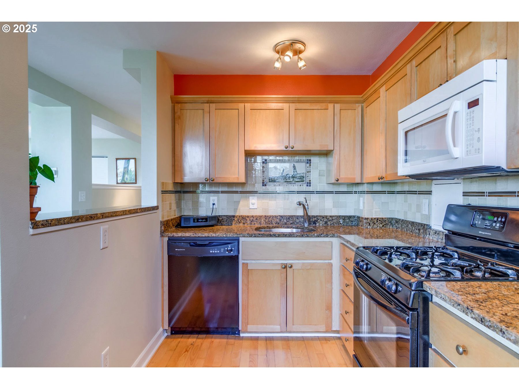 1205 Southwest Cardinell Drive, Unit 302 Portland, OR 97201 - Photo 12 of 23 a kitchen with stainless steel appliances granite countertop a stove and a sink