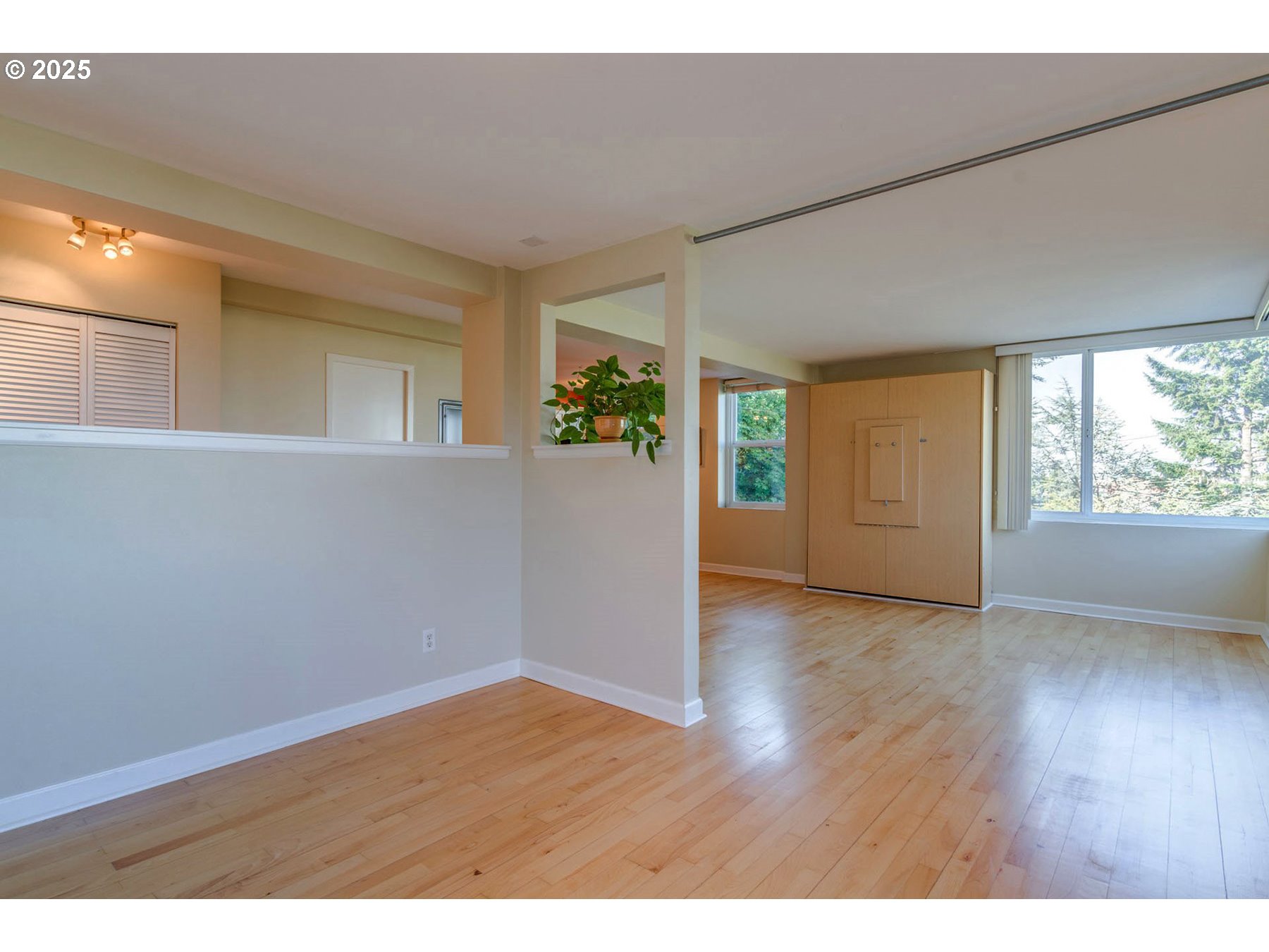 1205 Southwest Cardinell Drive, Unit 302 Portland, OR 97201 - Photo 18 of 23 a view of an empty room with wooden floor and a window