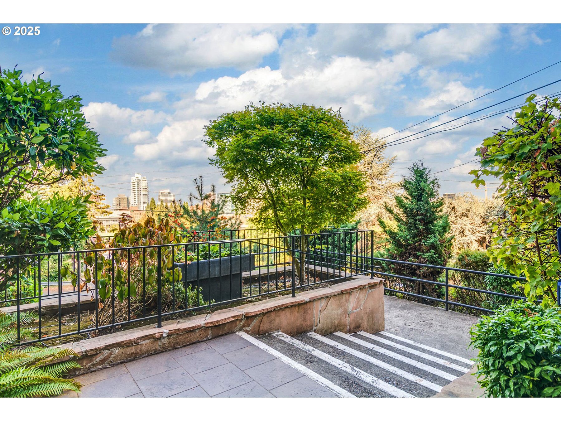 1205 Southwest Cardinell Drive, Unit 302 Portland, OR 97201 - Photo 23 of 23 a view of a balcony with floor to ceiling windows and wooden fence