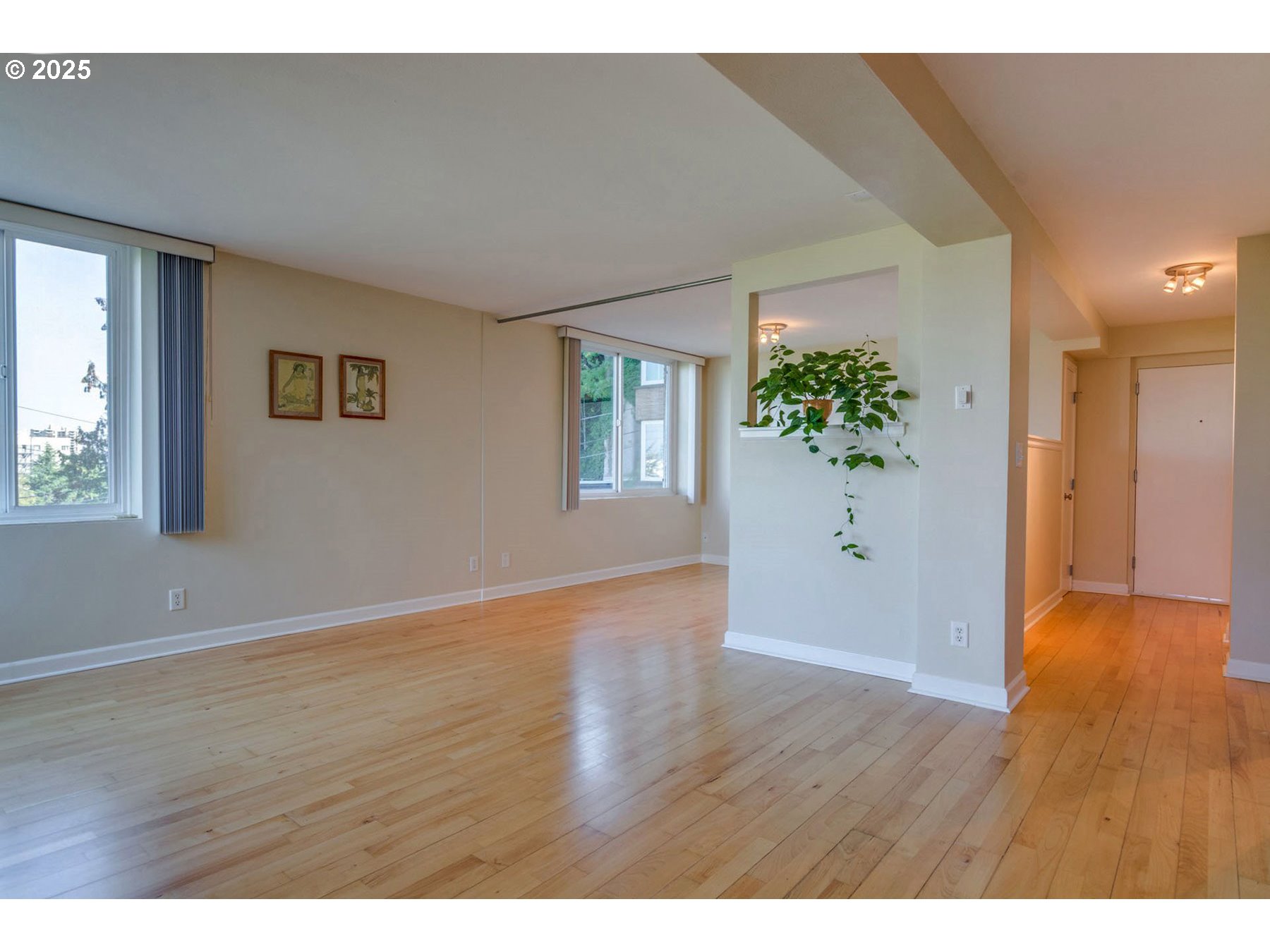 1205 Southwest Cardinell Drive, Unit 302 Portland, OR 97201 - Photo 3 of 23 a view of an empty room with wooden floor and a window