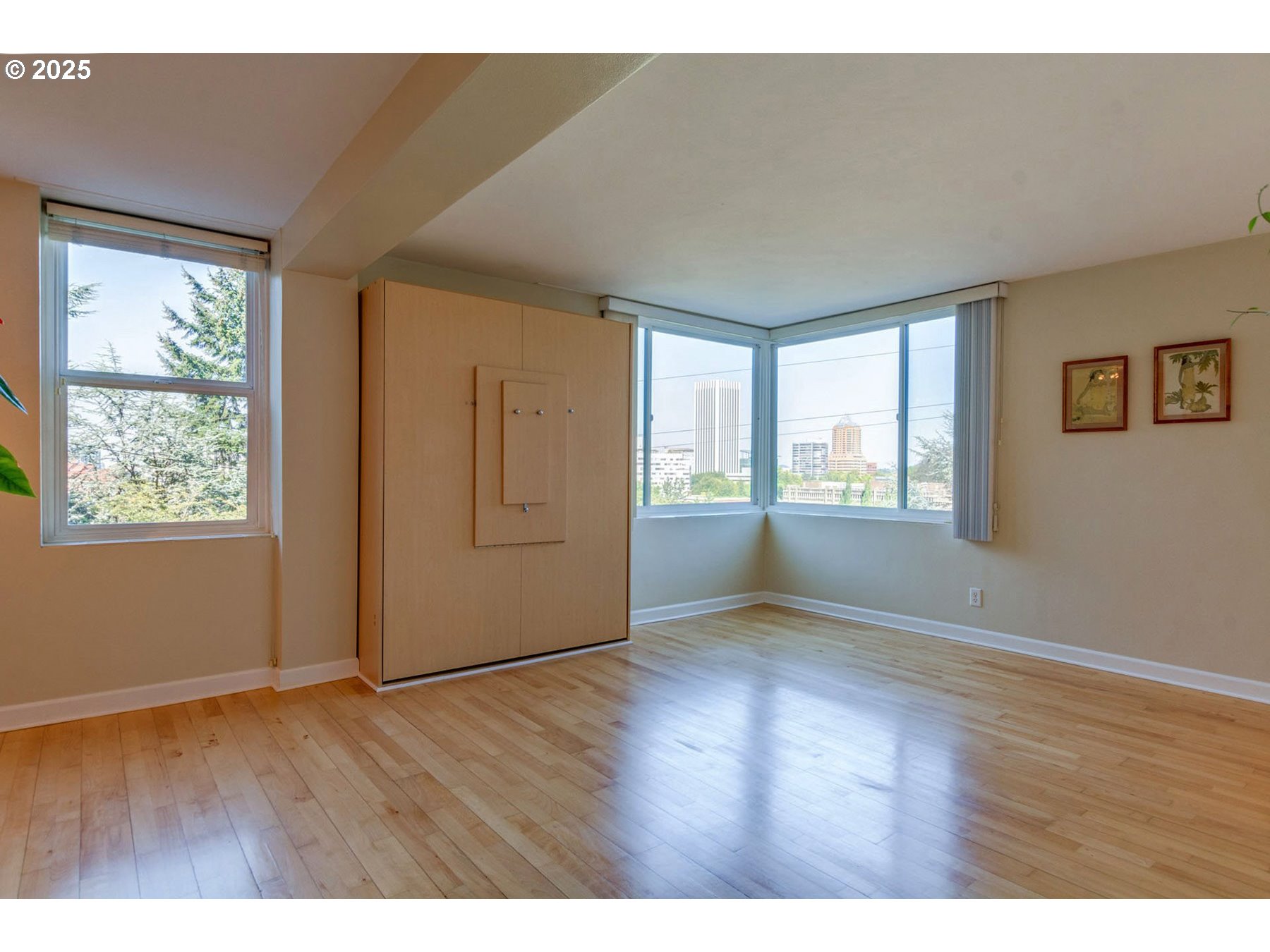 1205 Southwest Cardinell Drive, Unit 302 Portland, OR 97201 - Photo 4 of 23 a view of an empty room with wooden floor and a window