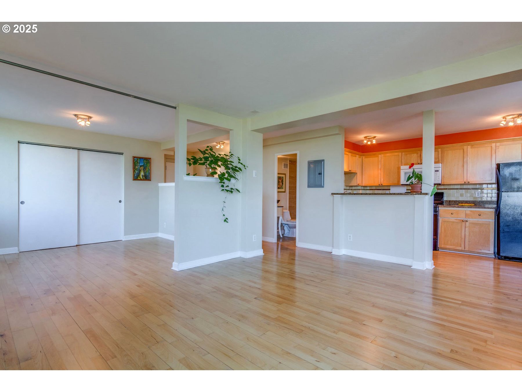 1205 Southwest Cardinell Drive, Unit 302 Portland, OR 97201 - Photo 8 of 23 a view of a kitchen with wooden floor and a kitchen
