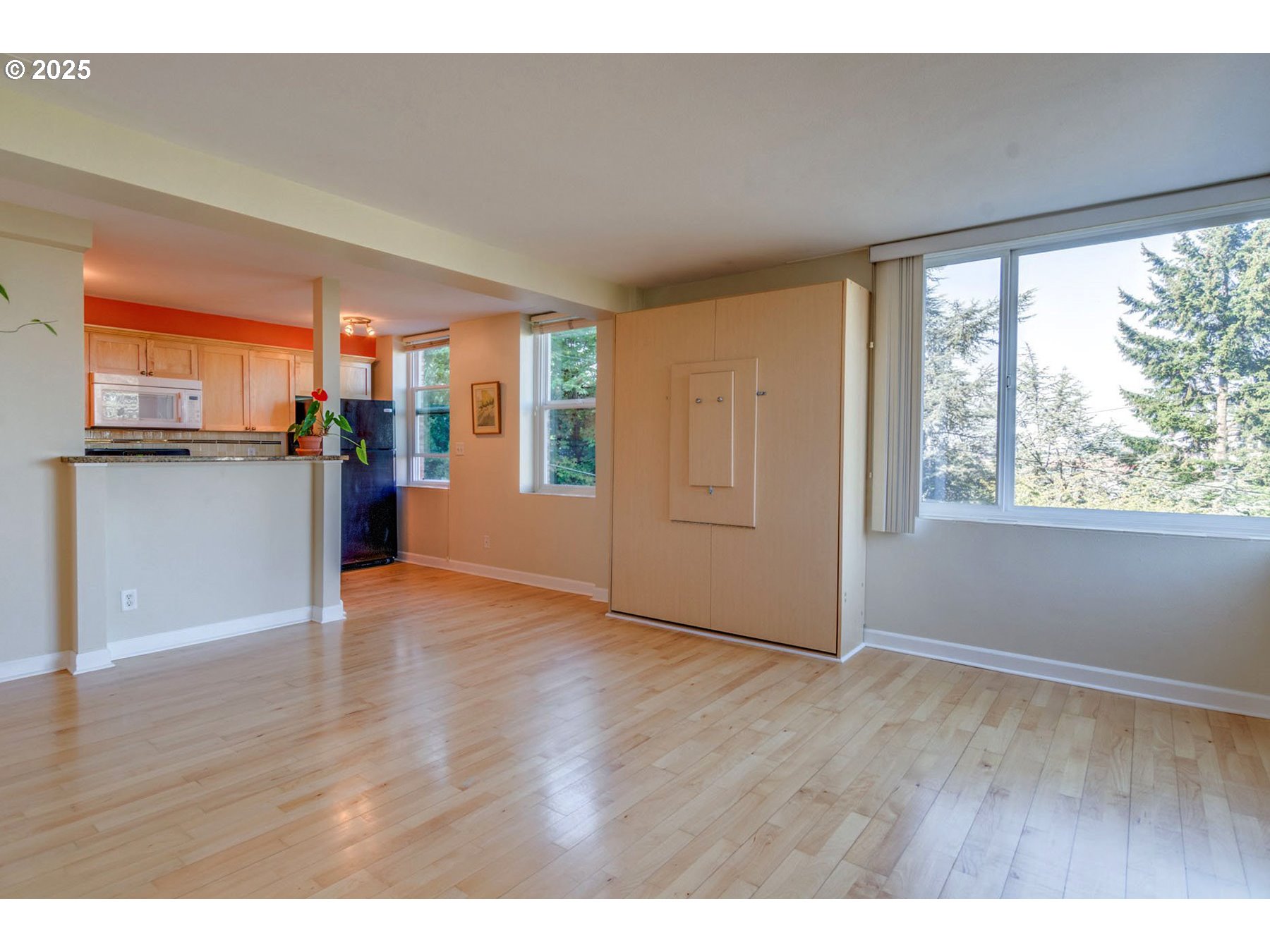 1205 Southwest Cardinell Drive, Unit 302 Portland, OR 97201 - Photo 9 of 23 a view of an empty room with a window and wooden floor