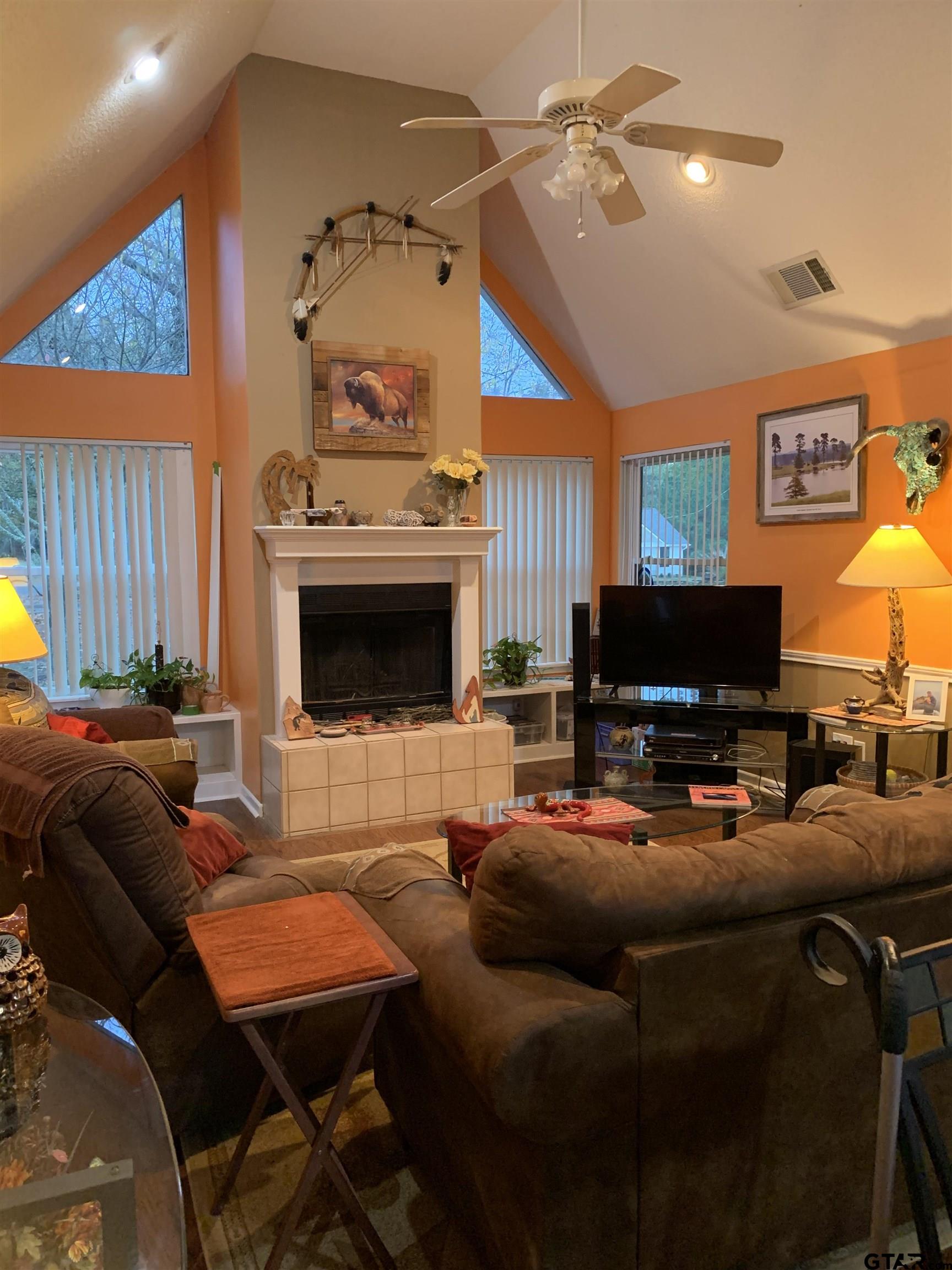 399 Cimarron Trail Holly Lake Ranch, TX 75765 - Photo 8 of 24 a living room with furniture a fireplace and a flat screen tv