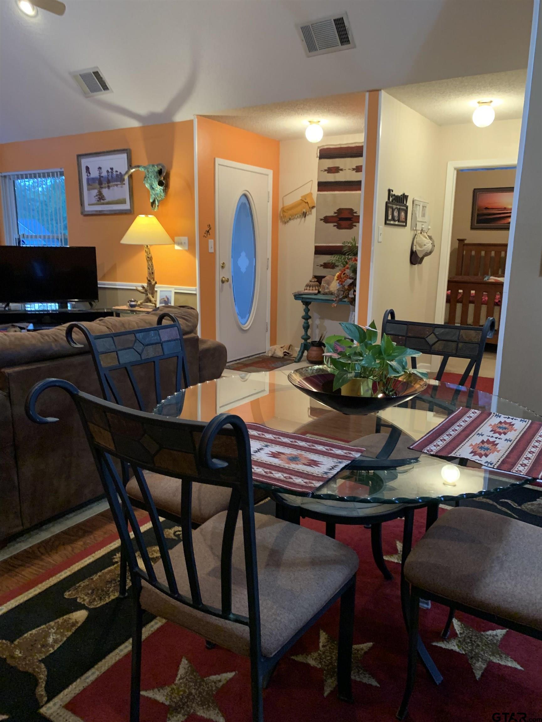 399 Cimarron Trail Holly Lake Ranch, TX 75765 - Photo 9 of 24 a view of a dining room with furniture and wooden floor