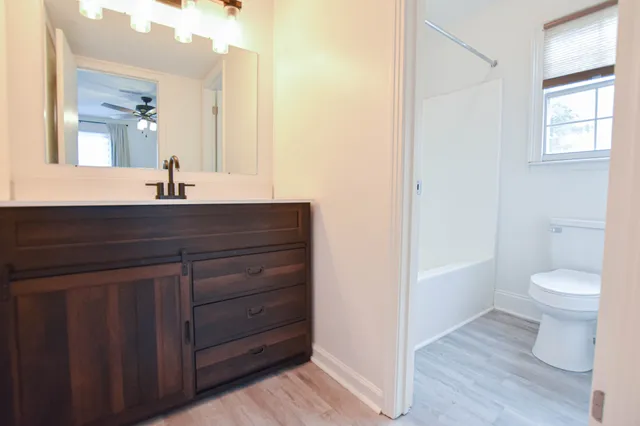 a bathroom with a sink a toilet and a mirror