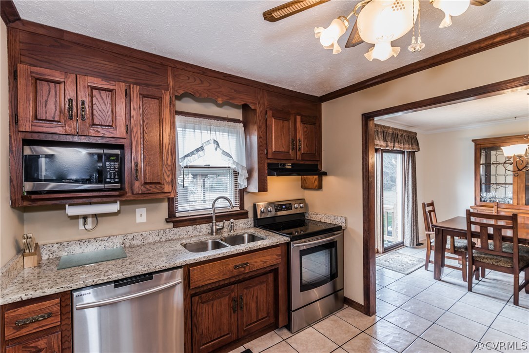 10623 River Road Chesterfield, VA 23838 - Photo 20 of 48 a kitchen with granite countertop a stove a sink and a microwave