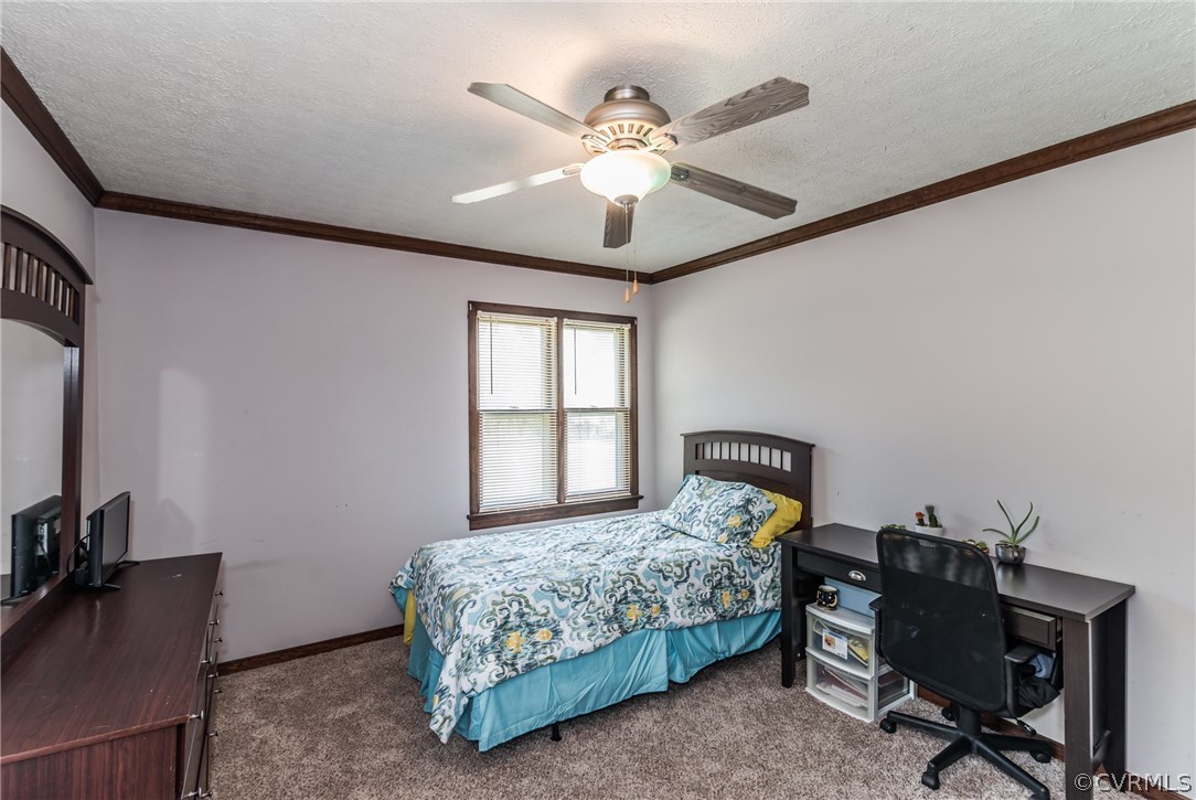 10623 River Road Chesterfield, VA 23838 - Photo 30 of 48 a bedroom with a bed and a chandelier