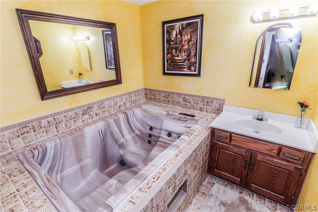 10623 River Road Chesterfield, VA 23838 - Photo 36 of 48 a bathroom with a bathtub and a mirror