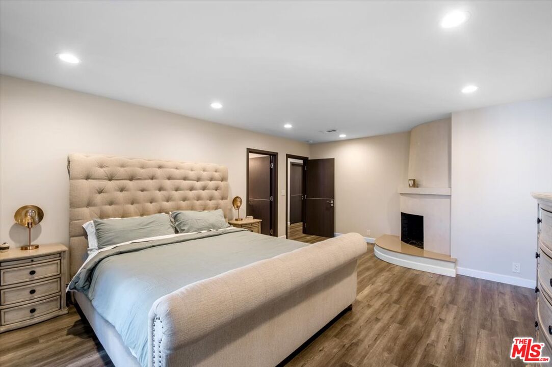 5705 Lemona Avenue Sherman Oaks, CA 91411 - Photo 11 of 30 a bedroom with a large bed and a chandelier