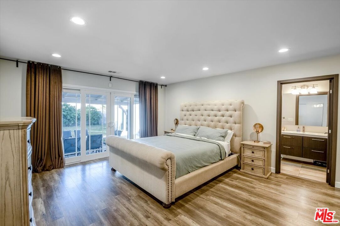 5705 Lemona Avenue Sherman Oaks, CA 91411 - Photo 12 of 30 a large bedroom with a bed and wooden floor