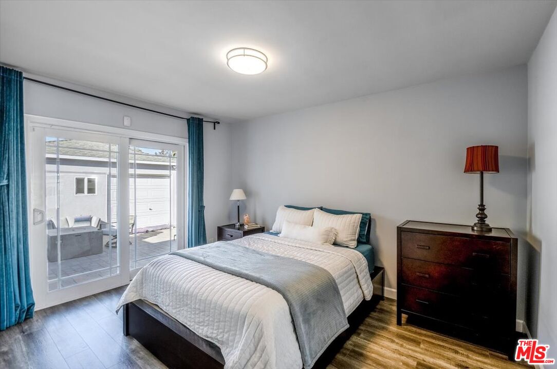 5705 Lemona Avenue Sherman Oaks, CA 91411 - Photo 14 of 30 a bedroom with a bed and a lamp next to a window