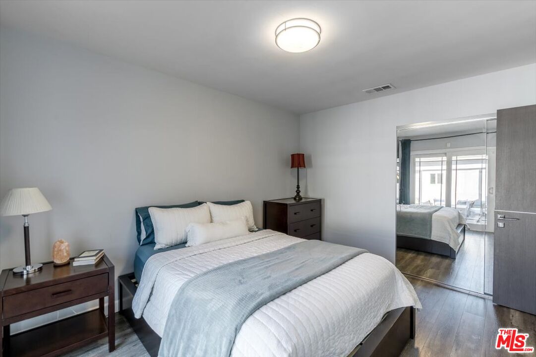 5705 Lemona Avenue Sherman Oaks, CA 91411 - Photo 15 of 30 a bedroom with a bed and a lamp on dresser