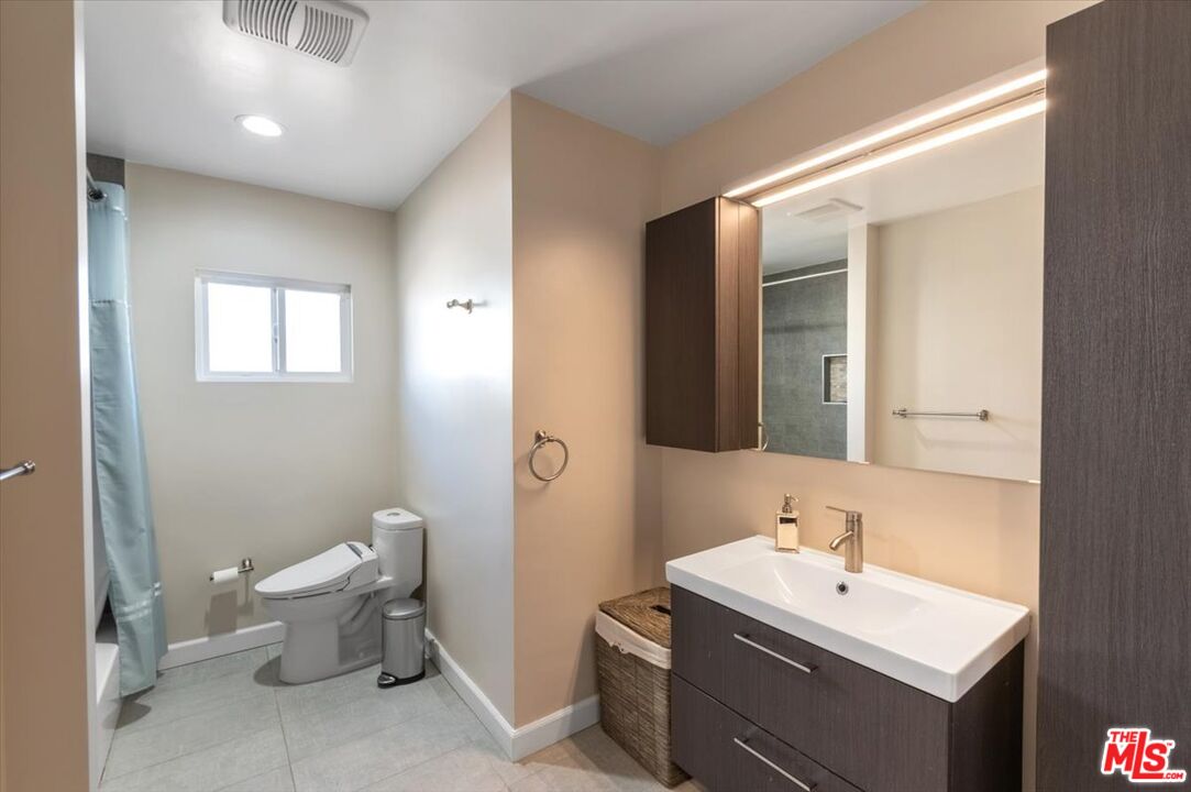 5705 Lemona Avenue Sherman Oaks, CA 91411 - Photo 19 of 30 a bathroom with a toilet sink and mirror