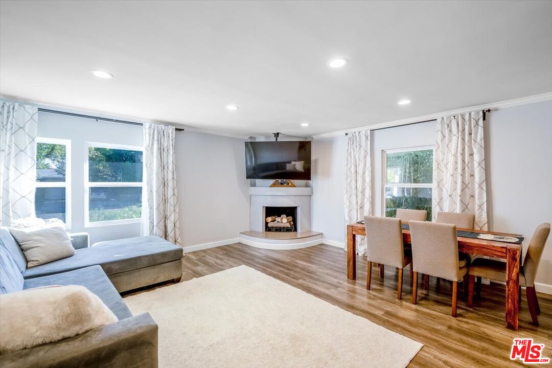 5705 Lemona Avenue Sherman Oaks, CA 91411 - Photo 2 of 30 a living room with fireplace furniture and a large window