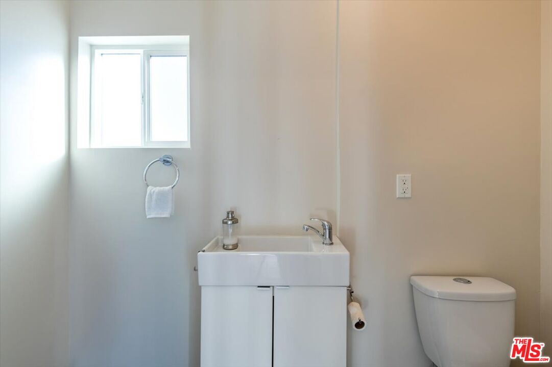 5705 Lemona Avenue Sherman Oaks, CA 91411 - Photo 22 of 30 a bathroom with a toilet sink and mirror