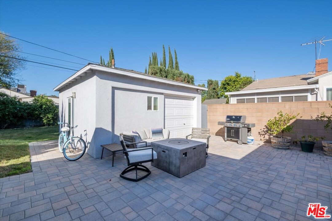 5705 Lemona Avenue Sherman Oaks, CA 91411 - Photo 26 of 30 a view of a patio with table and chairs potted plants and a large tree
