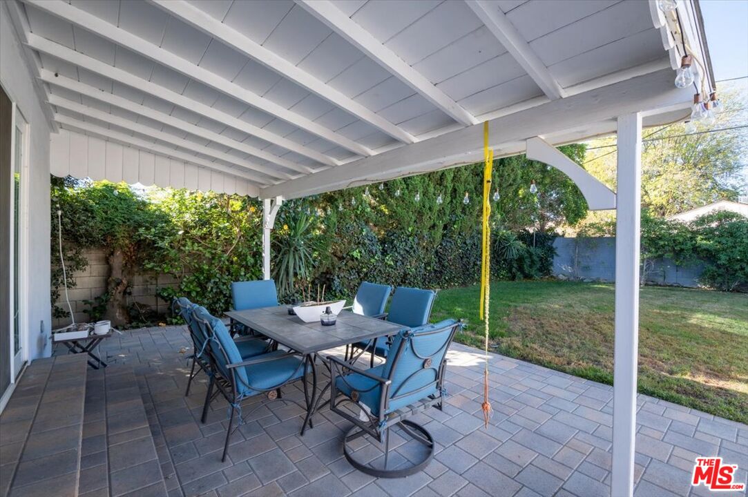 5705 Lemona Avenue Sherman Oaks, CA 91411 - Photo 30 of 30 a view of a patio with a table chairs and a backyard