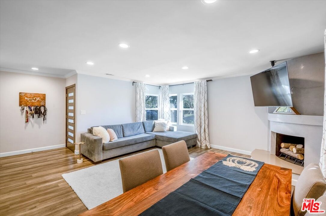 5705 Lemona Avenue Sherman Oaks, CA 91411 - Photo 3 of 30 a living room with fireplace furniture and a flat screen tv