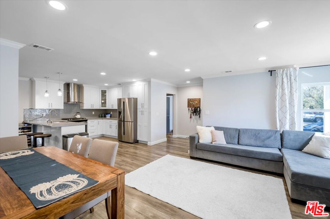 5705 Lemona Avenue Sherman Oaks, CA 91411 - Photo 5 of 30 a living room with kitchen island furniture and a view of kitchen