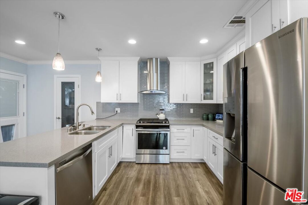 5705 Lemona Avenue Sherman Oaks, CA 91411 - Photo 7 of 30 a kitchen with a sink stove and refrigerator