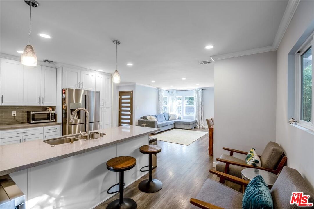 5705 Lemona Avenue Sherman Oaks, CA 91411 - Photo 9 of 30 a large room with gym equipment and a large window