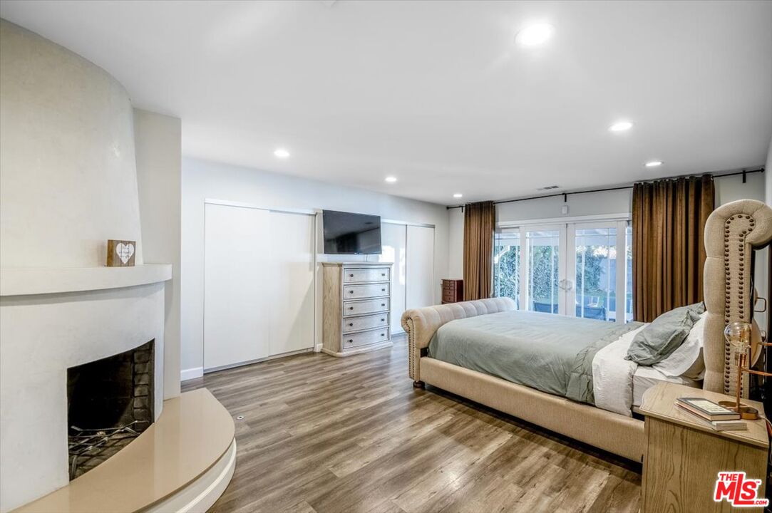 5705 Lemona Avenue Sherman Oaks, CA 91411 - Photo 10 of 30 a bedroom with a bed and a television