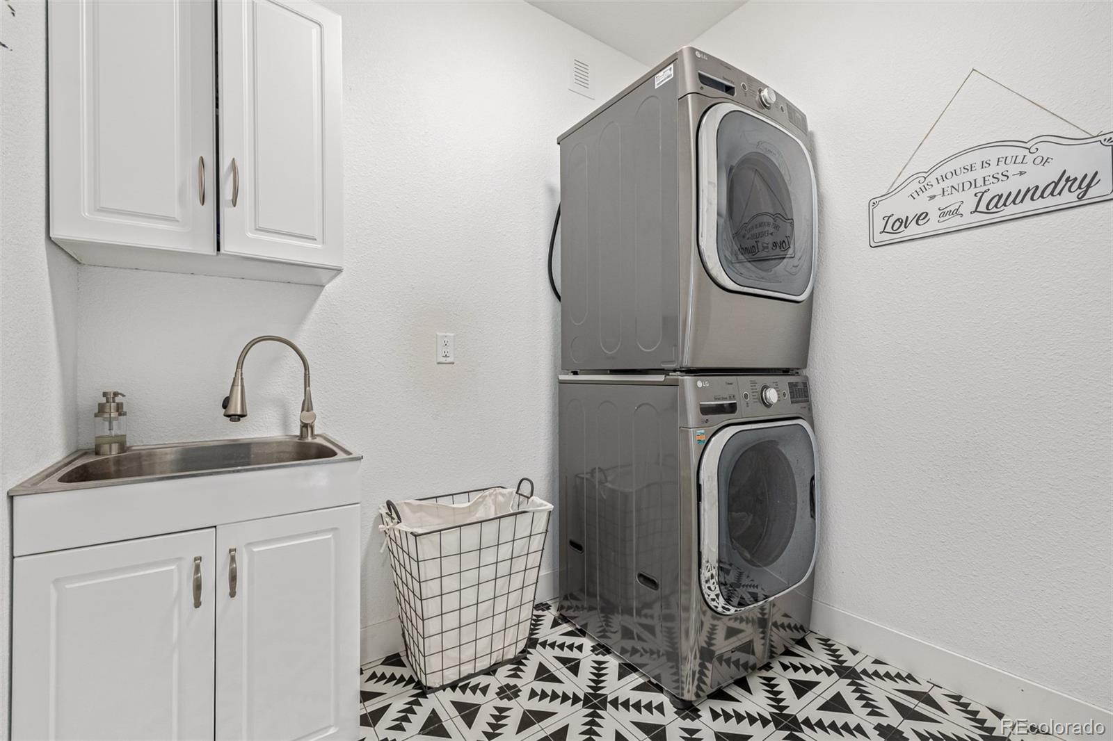 663 Brookside Drive Bailey, CO 80421 - Photo 27 of 47 a utility room with sink dryer and washer