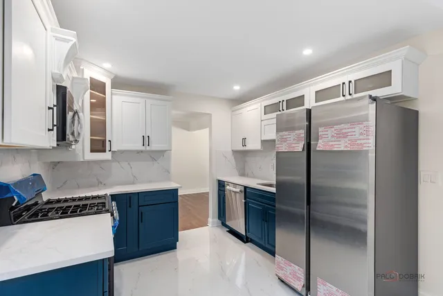 a view of an empty room with a fireplace and a window
