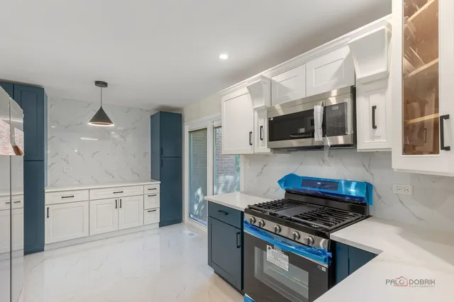 a view of empty room with window and wooden floor