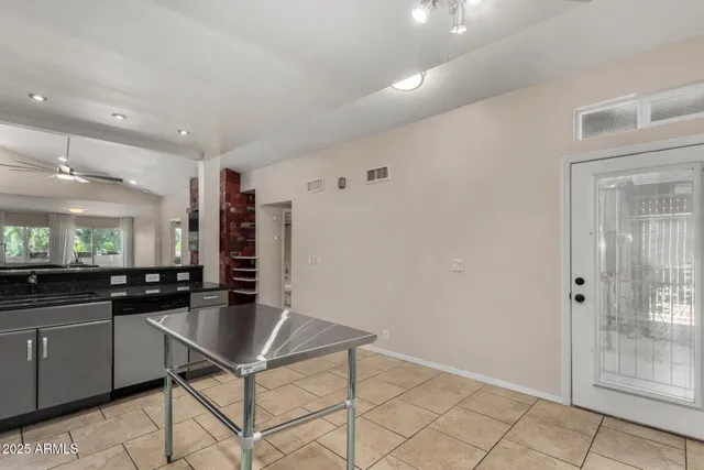 a kitchen with granite countertop a sink and cabinets