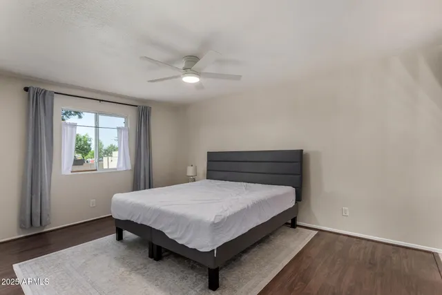 a bed sitting in a bedroom next to a window