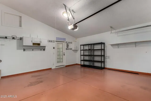 a view of empty room with stairs and a window