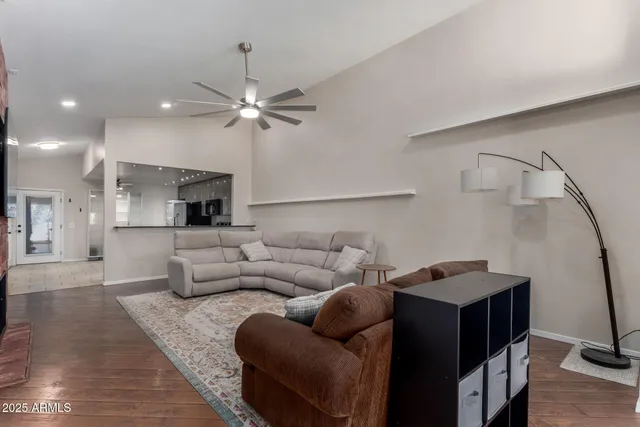 a living room with furniture and a ceiling fan