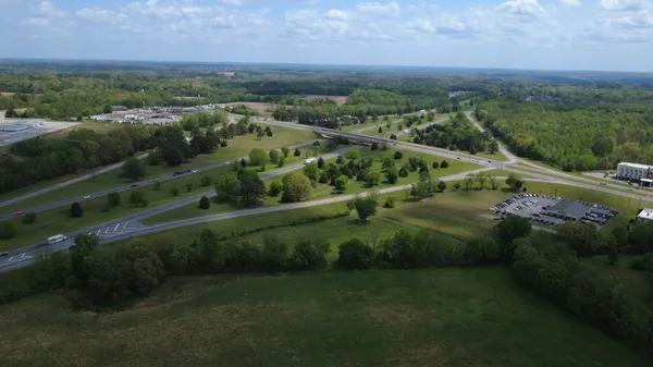 an aerial view of residential houses with outdoor space and river