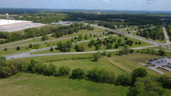 an aerial view of a residential houses with outdoor space and street view