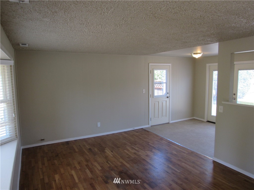 15925 53rd Place West Edmonds, WA 98026 - Photo 4 of 23 an empty room with wooden floor and windows