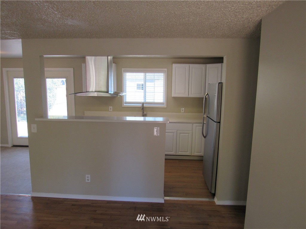15925 53rd Place West Edmonds, WA 98026 - Photo 5 of 23 a view of a kitchen with wooden floor and cabinets