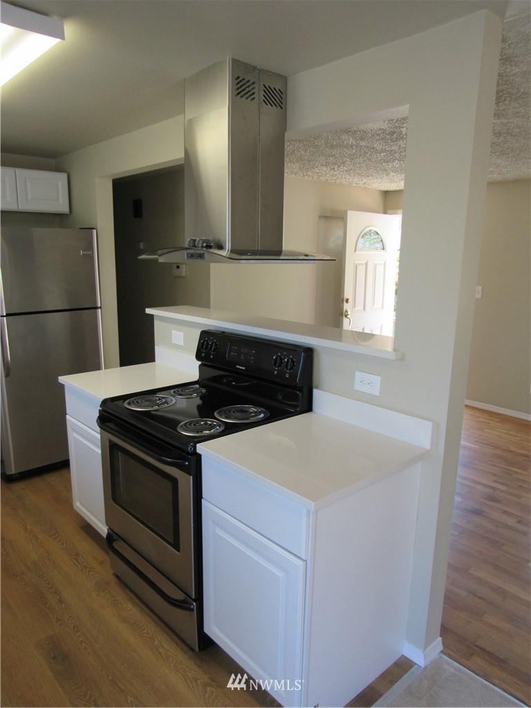 15925 53rd Place West Edmonds, WA 98026 - Photo 7 of 23 a kitchen with a stove and a microwave