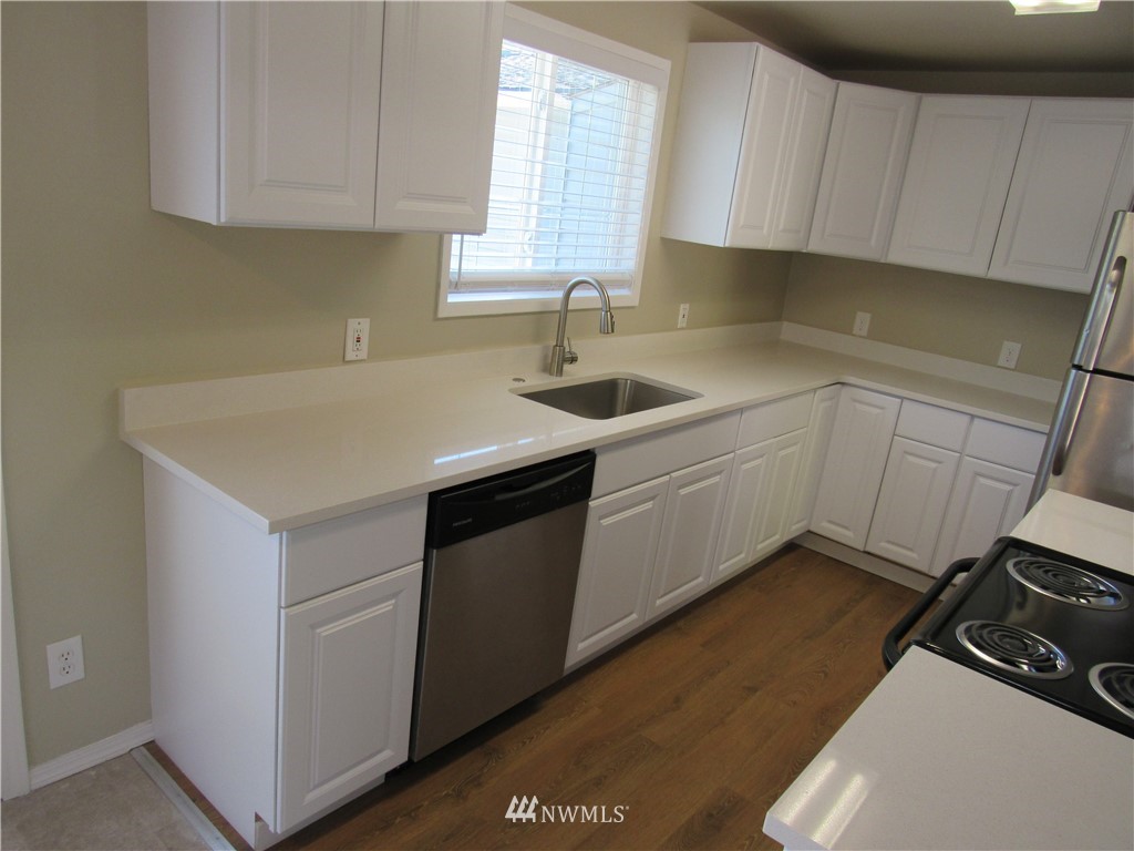 15925 53rd Place West Edmonds, WA 98026 - Photo 8 of 23 a kitchen with a sink stove and cabinets