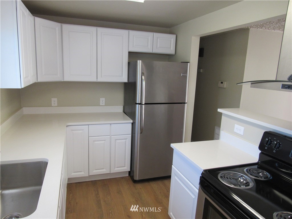 15925 53rd Place West Edmonds, WA 98026 - Photo 9 of 23 a kitchen with a refrigerator and a stove