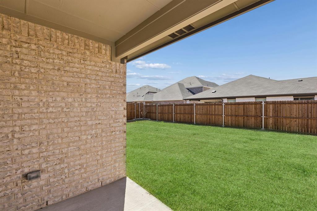 769 Sierra Ridge Lavon, TX 75166 - Photo 34 of 37 Covered Patio in the Harrison home plan by Trophy Signature Homes – REPRESENTATIVE PHOTO