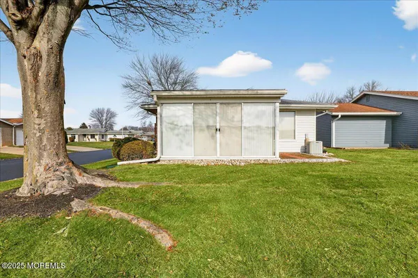 an aerial view of a house with a yard basket ball court and outdoor seating